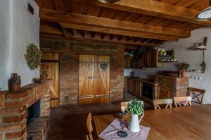 a kitchen with a table and a wooden door at Sklipek U Tomáša in Hovorany