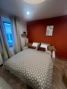 a bedroom with a large bed with an orange wall at Croix Rousse in Lyon +3 photos