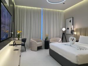 沙迦国敦大酒店客房内的一张或多张床位