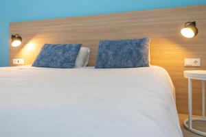 Postel nebo postele na pokoji v ubytování Flag Hotel Santarém