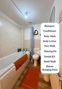 a bathroom with a bath tub and a toilet at The Chapel - Worcester City - FREE Parking, WI-FI, Toiletries - TVs in rooms - Stocked kitchen - Entire Apart - Self Check-In - Outside Space in Worcester +13 photos