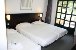 Postel nebo postele na pokoji v ubytování Flag Hotel Santarém
