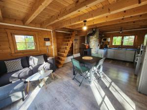 a living room with a couch and a table at Le Chalet « au Fil de l’eau » in Véreux +14 photos