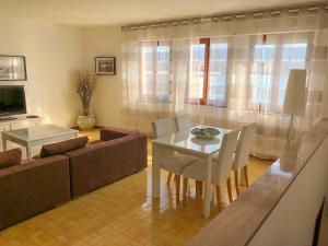 a living room with a table and a couch at Romantica Dimora Bocca di Magra in Bocca di Magra