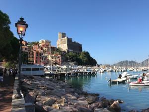 a street light next to a body of water with boats at Romantica Dimora Bocca di Magra in Bocca di Magra