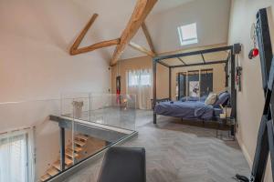 a bedroom with a bed and a glass floor at 7eme loft in Saint-Victor-de-Cessieu