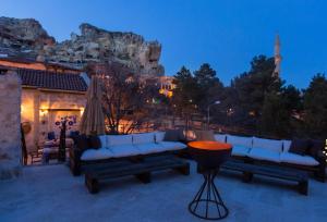 a patio with couches and a view of the mountain at Asuwari Suites Cappadocia in Ürgüp
