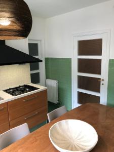 a kitchen with a table with a white plate on it at Romantica Dimora Bocca di Magra in Bocca di Magra +16 photos