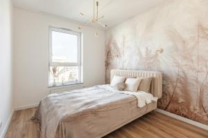 Łóżko lub łóżka w pokoju w obiekcie Apartamenty Novomiejska 17