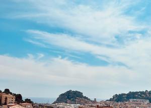 a view of a city with a cloudy sky at Villa Mediterranea Tossa in Tossa de Mar