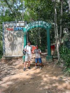 two boys standing in front of a bus stop at Backpacker Lodge in Bukit Lawang +30 photos