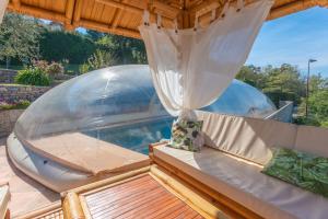 a hot tub in a glass dome on a deck at Chalet De Charme Tout Confort in Les Adrets de l'Esterel