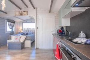 a kitchen with a sink and a bed in a room at Chalet De Charme Tout Confort in Les Adrets de l'Esterel +15 photos