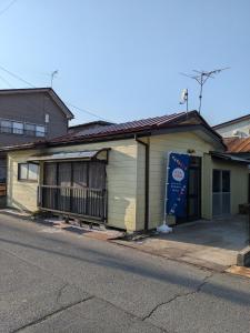 a building on the side of a street at Guest house AIZU First in Aizuwakamatsu