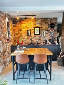 a kitchen with a wooden table and two chairs at Secret Place apartments, luxury and spa in Zdenci Brdovečki