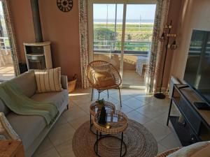 a living room with a couch and a table at CAP Baie Malo in Hirel