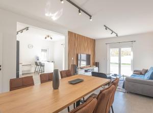 a dining room and living room with a table and chairs at Holiday Home Iva in Šibenik
