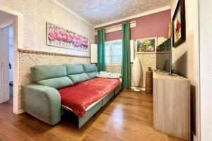 a living room with a couch and a television at Casa Estrada in Caleta de Interián