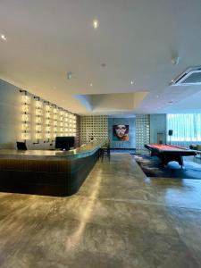 a room with a pool table and a ping pong table at BaBa Boutique House Langkawi in Pantai Cenang