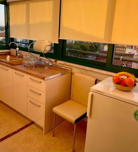 a kitchen with a bowl of fruit on a counter at In the Heart of Shkodra in Shkodër