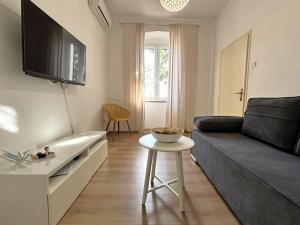 a living room with a couch and a table at Apartments Del Mare in Crikvenica