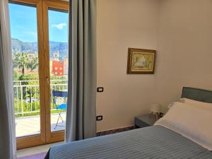 a bedroom with a bed and a view of a balcony at Casa Evelina in Sant'Agnello