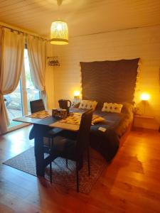 a bedroom with a bed and a table with a tableablish at OFILDLEAU in Sillans-la Cascade +25 photos