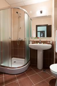 a bathroom with a shower and a sink at Saint George Palace Hotel All-inclusive in Sveti Vlas