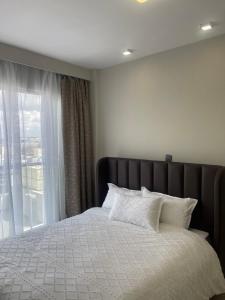 a bedroom with a bed with a large window at Hideaway holiday in Nairobi +9 photos