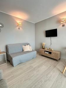 a bedroom with a bed and a flat screen tv at DonAna 308 in Lagos +10 photos