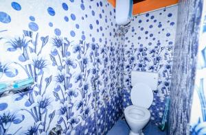 a blue and white bathroom with a toilet at Aishwarya Heritage Villa in Vattavada +74 photos