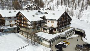 an aerial view of a large house in the snow at La Trinitè Monboso Hotel in Gressoney-la-Trinité