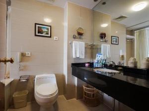 a bathroom with a white toilet and a sink at Super House International in Beijing