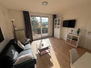 a living room with a couch and a table at Hahnenkleer Tied 2 in Goslar