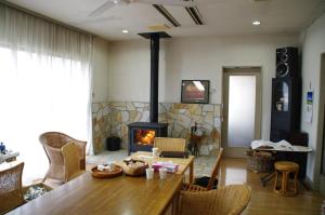 a living room with a table and a fireplace at 栃木迎賓館 in Tochigi