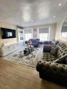 a living room with two couches and a tv at Gucci flat in Knightsbridge in London