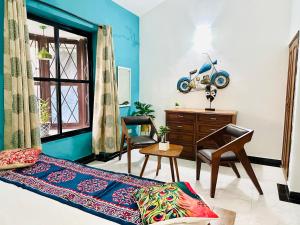 a bedroom with a bed and a desk and a chair at Duplex 2bhk Luxury Villa Near Baga in Arpora