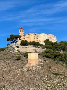 a large building on top of a hill at Apartament Marina Cullera in Cullera
