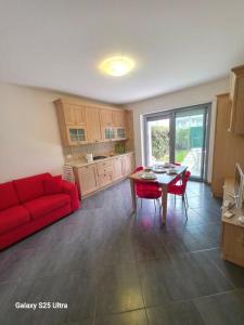 a living room with a red couch and a table at Macrinum - LE DUNE in Silvi Marina +6 photos