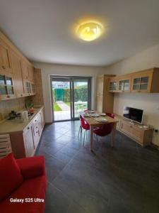 a kitchen with a table and red chairs in it at Macrinum - LE DUNE in Silvi Marina