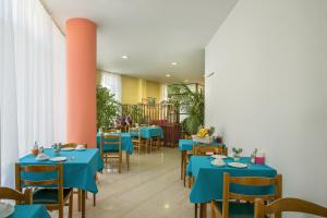 a dining room with blue tables and chairs at Nefeli Hotel in Athens