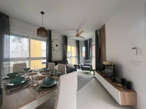 a living room with a dining table and a television at Vera Albacora de Luxe in Vera