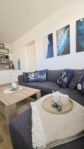a living room with a couch and a table at Westwind - schöne neue 2-Zi Whg 37qm für 1-4 Pers in Juist