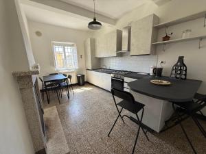 a kitchen with a black island in a room at La Casa al Castello in Lucca