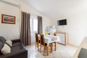 a kitchen and dining room with a table and chairs at Villa K&F Borik in Zadar