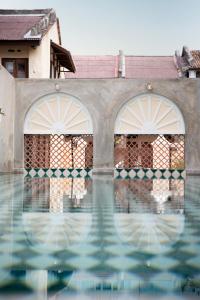 a swimming pool with a statue of an elephant in it at Jawi Peranakan Mansion in George Town