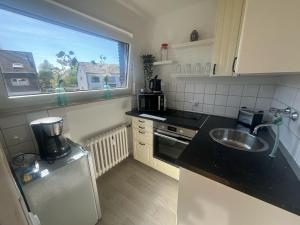 a small kitchen with a sink and a window at Wohnglück 2 in Herten