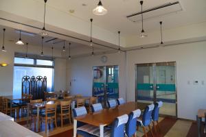 a dining room with a table and chairs at Hotel Plaza Arakawaoki in Tsuchiura
