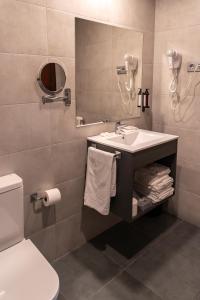 a bathroom with a sink and a mirror at Tudel in Andorra la Vella +32 photos