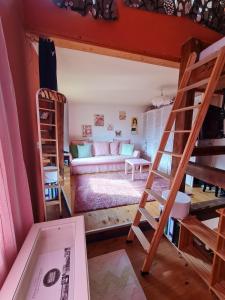a room with two bunk beds and a couch at Berthi's Townhouse in city center in Greifswald